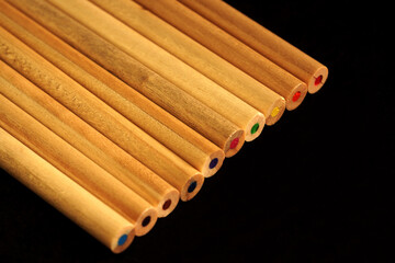 Colored crayons on a black background.                      
