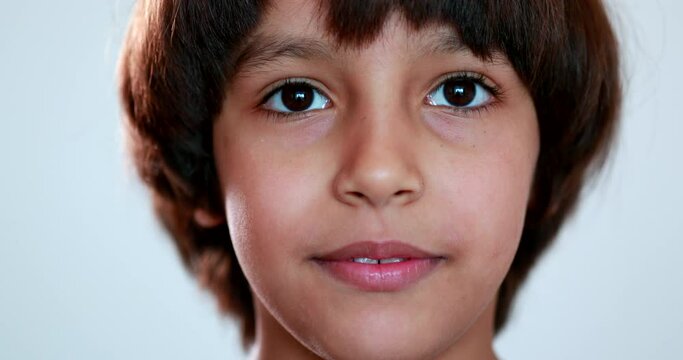 Pensive mixed race boy closeup face child thinking
