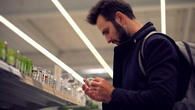 Man In Market Choosing Led Lamp. Businessman In Supermarket.Shopping In Hypermarket Mall On Electronic Device Store Section.Bayer Guy Choose Lamp For Home. Customer Looking On Product In Consumer Shop