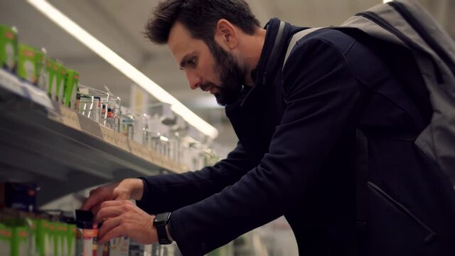 Man In Market Choosing Led Lamp. Businessman In Supermarket.Shopping In Hypermarket Mall On Electronic Device Store Section.Bayer Guy Choose Lamp For Home. Customer Looking On Product In Consumer Shop