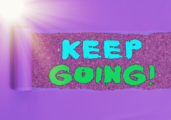 Conceptual hand writing showing Keep Going. Concept meaning to continue living normally despite the...