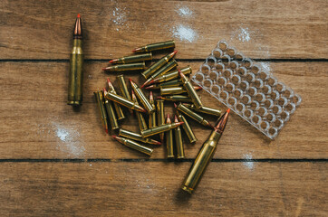 17HMR and .308 Ammunition Flat Lay on board surrounded by powder