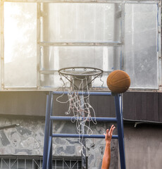Player layup a ball in basketball game, Defective net and loop, outdoor exercise
