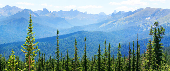 Taiga and the summits of the Sayan Mountains, Natural Park Ergaki. Panoramic view. Siberian nature, traveling in Russia.