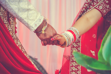 Fototapeta na wymiar Indian Hindu wedding ceremony and pooja ritual items, hands, and decorations close ups