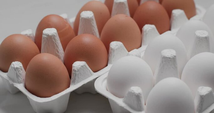 White and brown chicken egg in pack