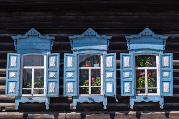 Windows in an old wooden house in the Siberian village