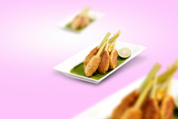 Satay wrapped, traditional Balinese food, isolated in shades of purple. Satay made from a mixture of fish and chicken meat and flour, wrapped around a skewer.