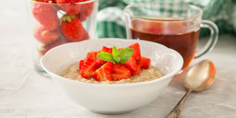 porridge with strawberry on a table, selective focus