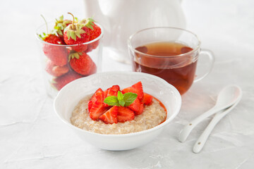 porridge with strawberry on a table, selective focus
