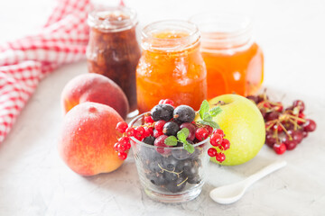 Fototapeta na wymiar berries, fruit and jam on a table, selective focus