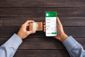 Money Transfer. Man Using Online Payment Application On Smartphone And Credit Card