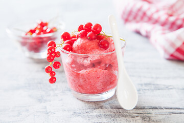 ice cream with berries in a glass on a table, selective focus
