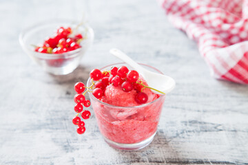 ice cream with berries in a glass on a table, selective focus