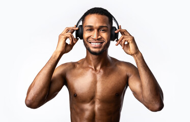 Fototapeta na wymiar Muscular Guy Listening Music Fitness Playlist Wearing Headphones, Studio Shot