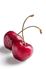 red cherry berry macro with drops of water at white background, isolated