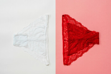 White women's panties on a white background and red on red. Underwear. The view from the top.