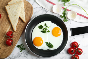 Flat lay composition with tasty fried chicken eggs on white marble table