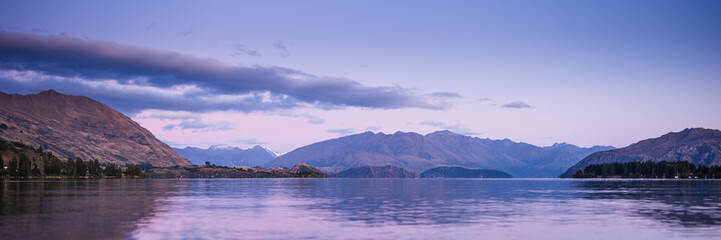 Mountain Lake Sunrise Landscape. Lake Wanaka New Zealand. Beautiful Morning Light Mountains Panorama Landscape Banner Background