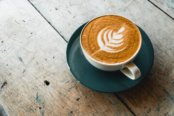 Coffee latte close up on rustic wood table. Coffee latte art. Cafe and restaurant