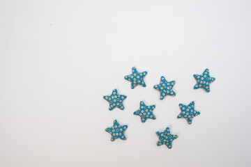 Star shaped hand crafted decoration on a white background with a blank space.