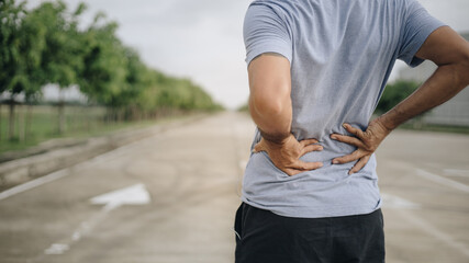 Sport man feeling backache outdoors