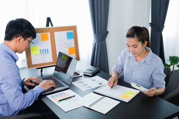 Businessmen present to the flipchart during the presentation of the earnings, consult the business performance report, check the report data.