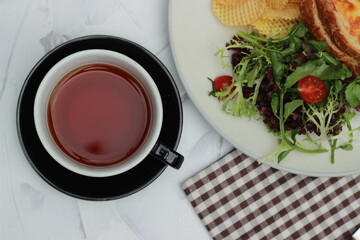 Tea in cups, napkins and a plate of healthy food. Food Fotography. Top view