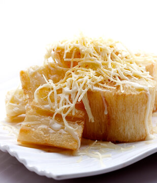 Cassava cheese. Fried cassava sprinkled with grated cheese and sweetened condensed white milk.