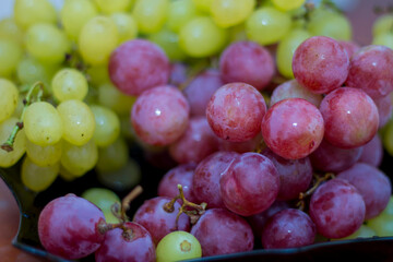 Red and White wine bunch of grapes in the black plate
