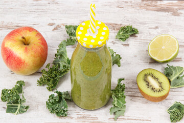 Freshly blended green coctail from fruits and vegetables as healthy dessert containing vitamins and...