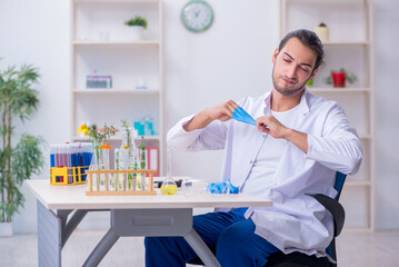 Young male chemist working in the lab