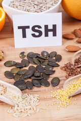 Inscription TSH with products and ingredients as source healthy vitamins and minerals. Beneficial eating for thyroid gland