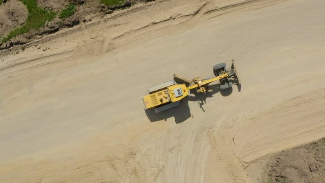 Grader Road Construction Grader industrial machine on construction of new roads. Aerial shot