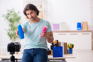 Young male shopaholic recording video for his blog