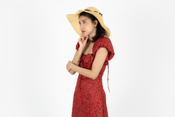 Upset stressed young Asian woman in red dress feeling in depression over white isolated background.