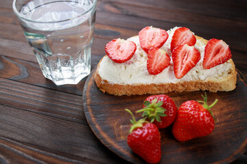Strawberry bruschetta with cottage cheese. Homemade healthy toast, delicious snack for kids. Fruit sweet sandwich with ripe summer berries