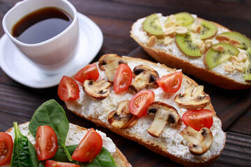 Assorted bruschettas with various toppings. Appetizing healthy homemade snacks, vegetarian toasts with fruits, vegetables and mushrooms. Balanced food, Italian antipasti variation