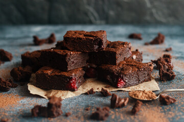 Tasty chocolate brownie with cherry. Pieces of cake on the table