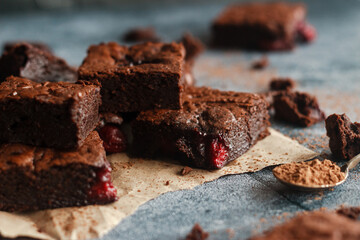 Tasty chocolate brownie with cherry. Pieces of cake on the table