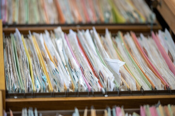 Financial and accounting documents are stored in a file cabinet.