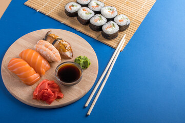 Fototapeta na wymiar Composition with delicious nigiri sushi and rolls