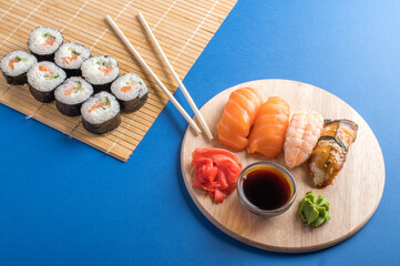 Sushi rolls set served on wooden board