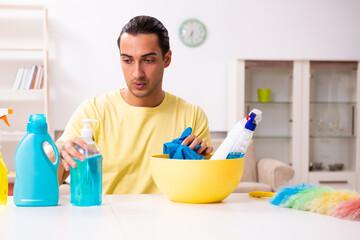 Young male contractor doing housework at home