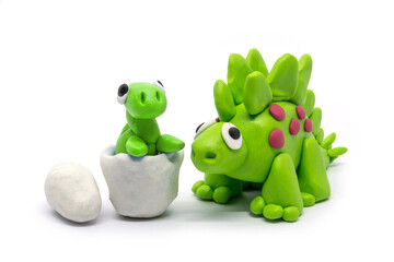 Play dough Stegosaurus and egg on white . Handmade clay plasticine - obrazy, fototapety, plakaty