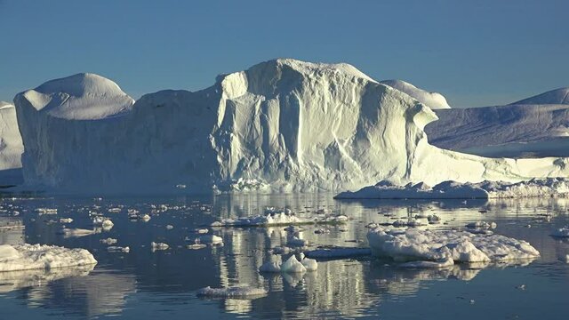 Greenland. Icebergs. Global warming and melting glaciers. Travel on the vessel among ices. Ices and icebergs of unusual forms and colors.
