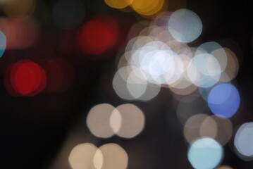 Fototapeta premium Colorful lens flare dot from the head lamp of the traffic