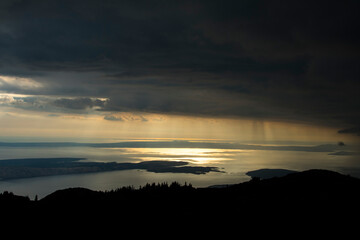 Rainy sunset above the Adriatic sea photographed from Zavizan on the Velebit mountain in Croatia. The islands Cres and Lošinj in distance.