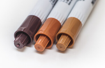Fototapeta premium A set of brown markers on a white background