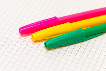 Three different colored ballpoint pens on paper
